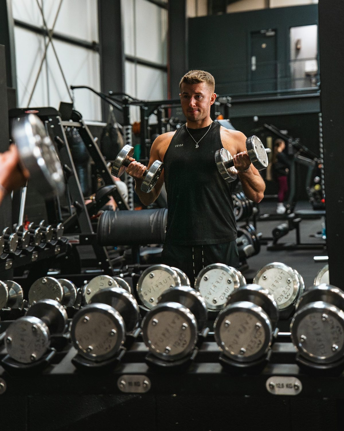 Athlete training with dumbbells in a gym